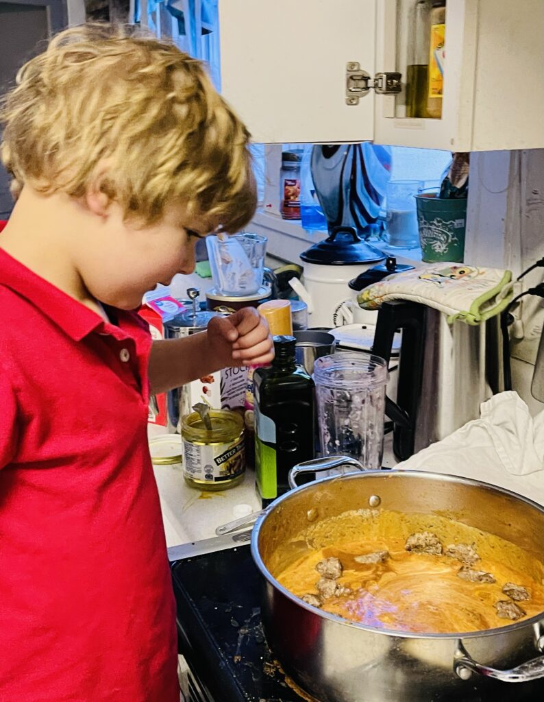 A 5-year-old boy prepares Ukranian tefteli (porcupine meatballs) as part of a homeschool leson. Photo by Kate Wehr